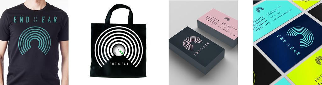 End of an Ear applied to merchandise — a t-shirt, tote bag, and business cards using the arc mark