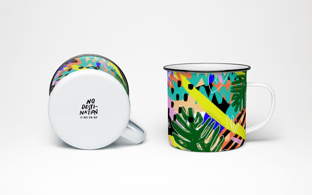 An enamel camp mug in the No Destination pattern, with the hand-lettered logo on the base
